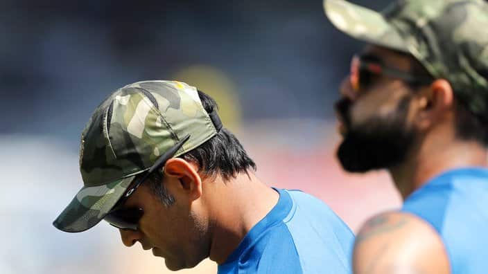 India's captain Virat Kohli, right, and teammate  Dhoni sport camouflage caps during India vs Australia match.