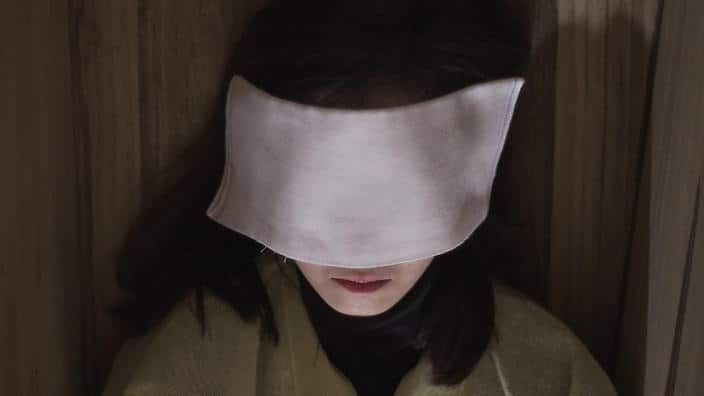 Christine Heiyeon Myung lying in her coffin during the fake funeral ceremony.