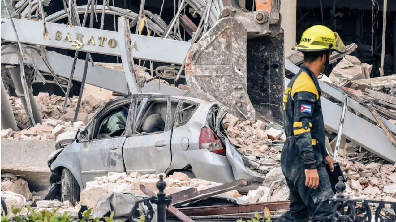 A rescuer helps after a huge blast wrecked the Saratoga Hotel in Havana on 6 May, 2022