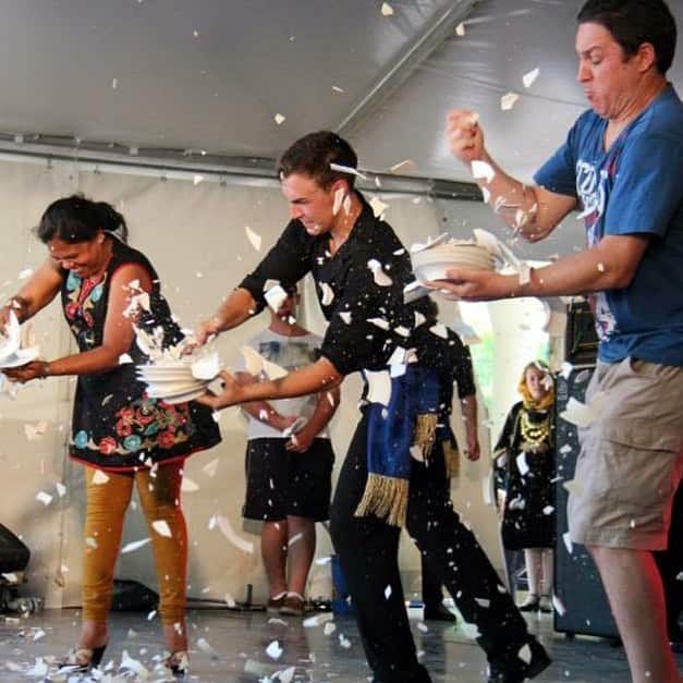 Greek festival attendeees breaking plates