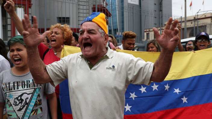 Venezuelan citizens protest the second term of Venezuelan President Nicolas Maduro outside the Venezuelan embassy in Lima, Peru. 
