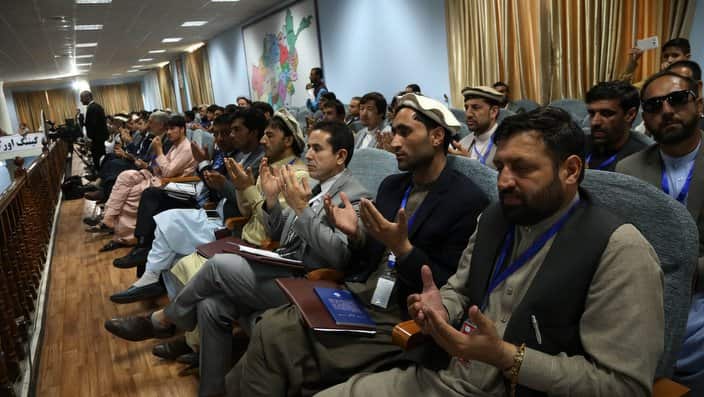 Afghan men pray as they attend during first day of the "loya jirga" (grand assembly) in Kabul, on April 29, 2019.
