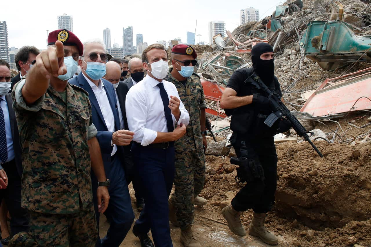 French President Emmanuel Macron (C) visits the devastated site of the explosion at the port of Beirut, Lebanon, 06 August 2020