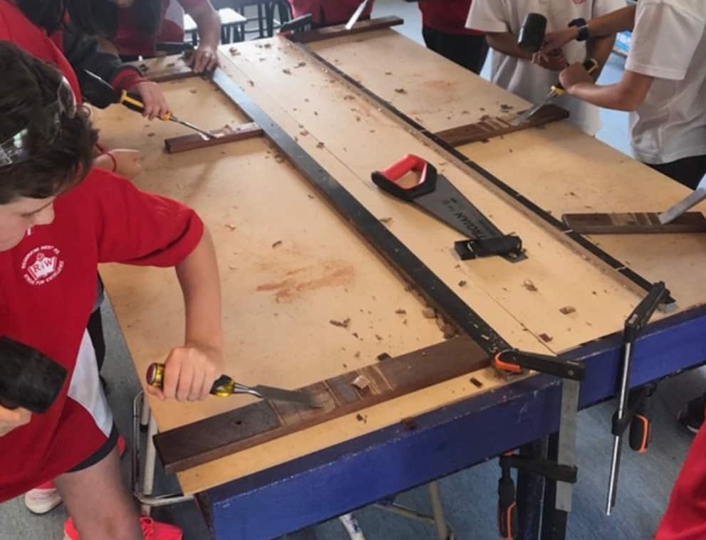 Students of Reservoir West Primary School making marimbas under the supervision of teacher and artist Jorge Leiva