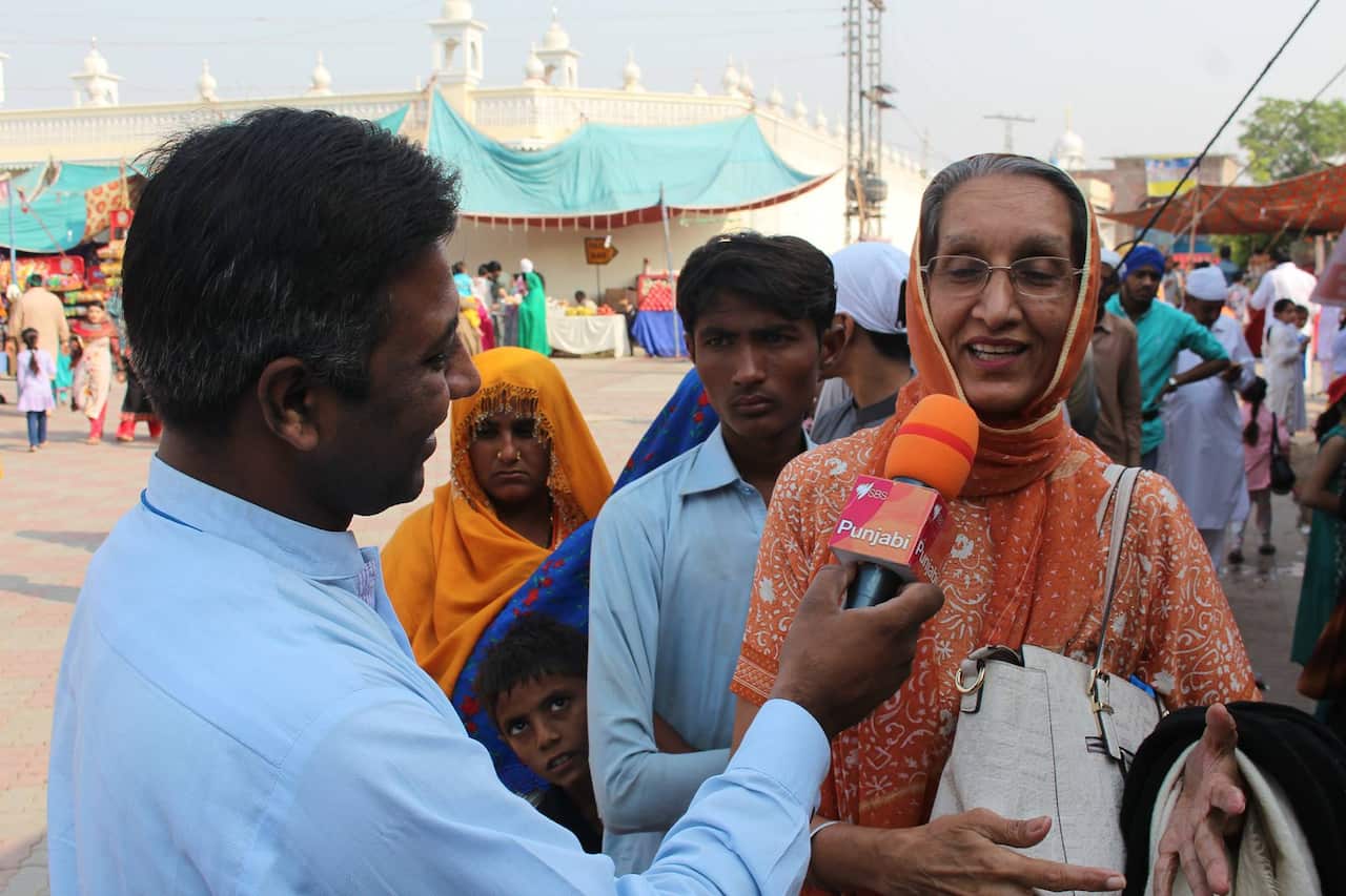 Pilgrims with Masood Mallhi at Gurudwara Janamasthan, Pakistan