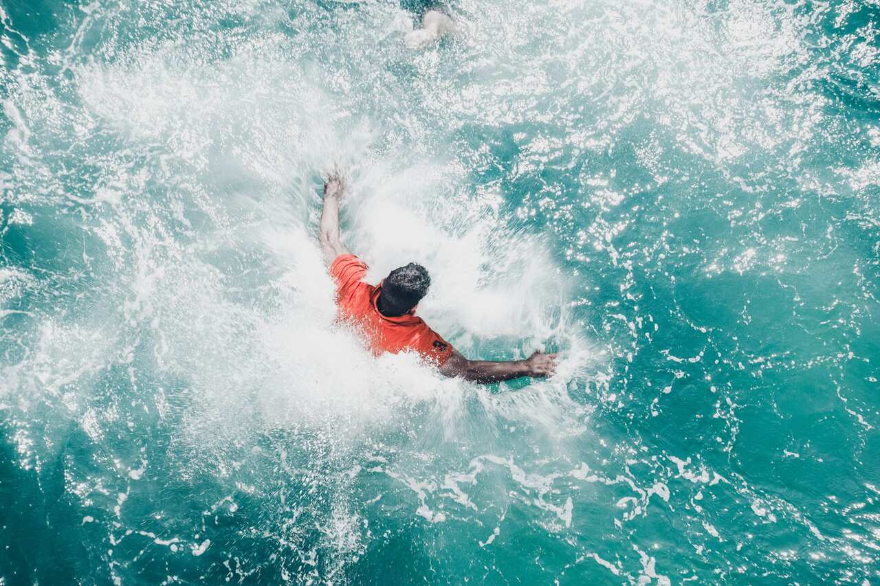 Man swimming in water