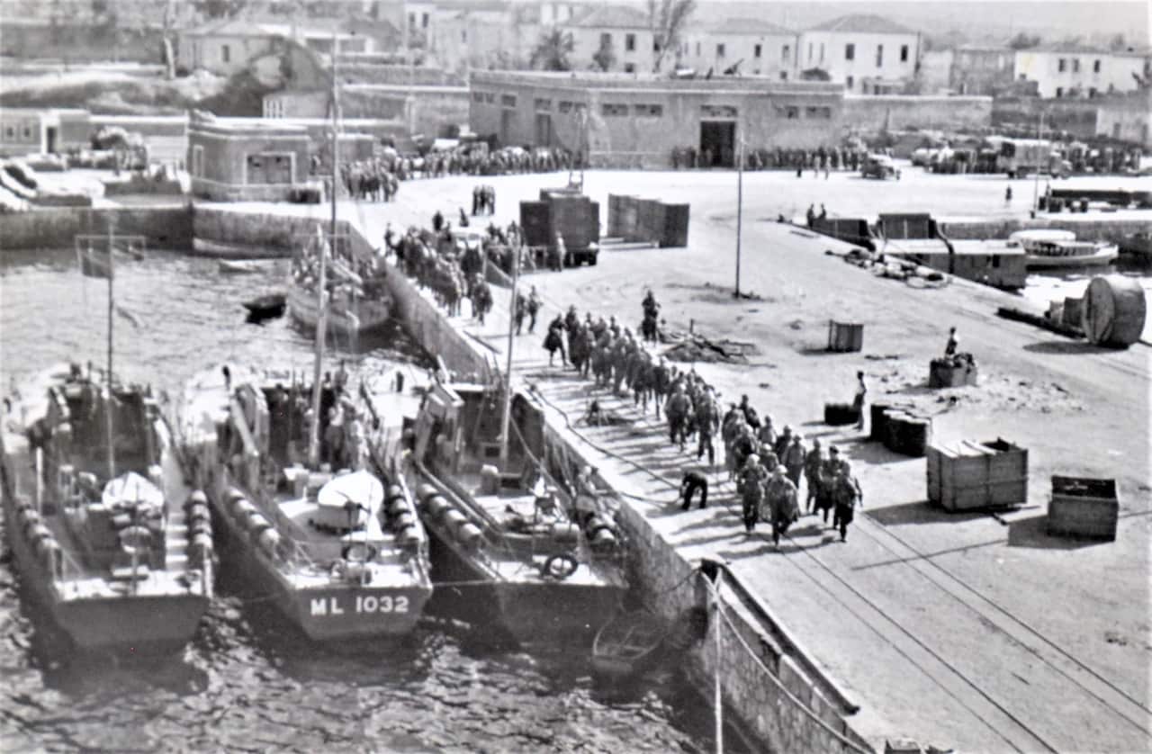 “Marching down to the Lossybank.” Allied troops boarding transports in Suda Bay, Crete, May 1941.