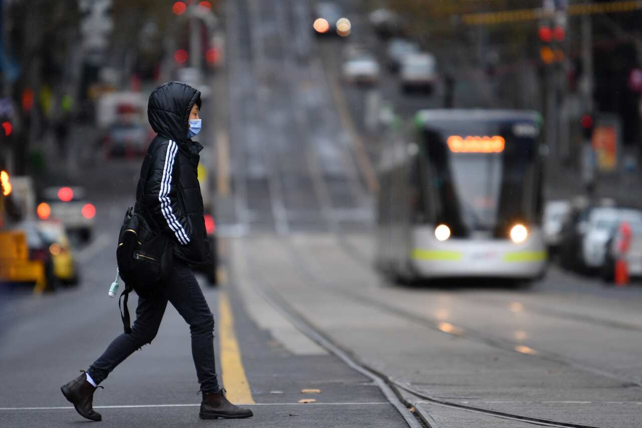 A person is seen wearing a face mask in Melbourne, Friday, June 4, 2021. Victoria has recorded four new locally acquired cases of coronavirus in the past 24 hours. (AAP Image/James Ross) NO ARCHIVING