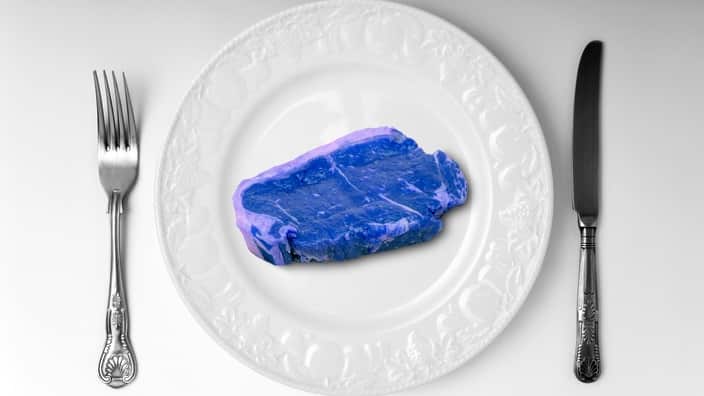 Blue meat on white plate