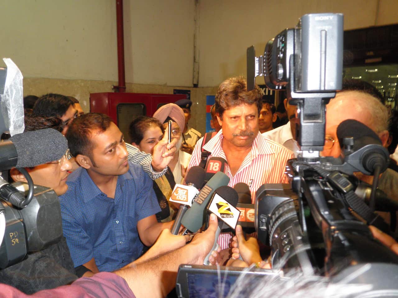 A media scrum awaits the arrival of Pooran's ashes in India