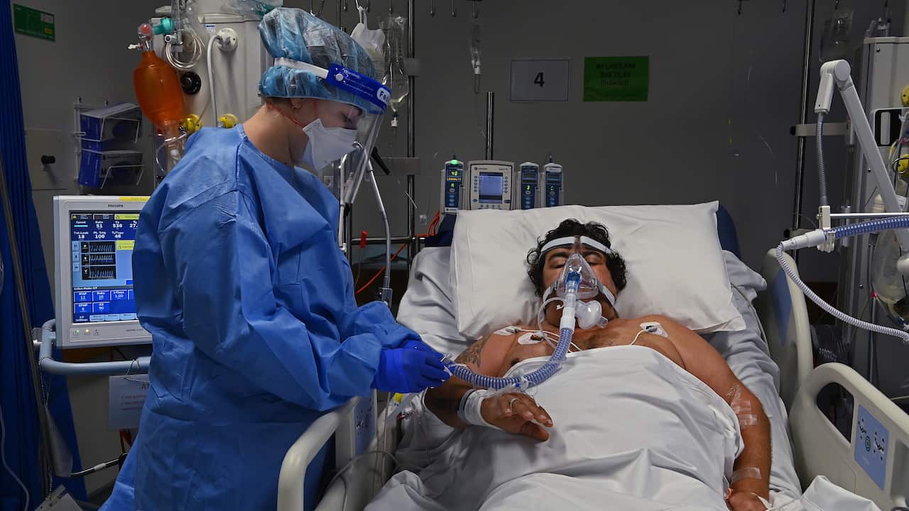 A supplied image of ICU Registered Nurse Shaunagh Whelan (left) caring for a COVID-19 positive patient in the ICU of St Vincents Hospital in Sydney, Tuesday, July 13, 2021. (AAP Image/Supplied by Kate Geraghty/SMH/St Vincents Hospital) NO ARCHIVING, EDITO