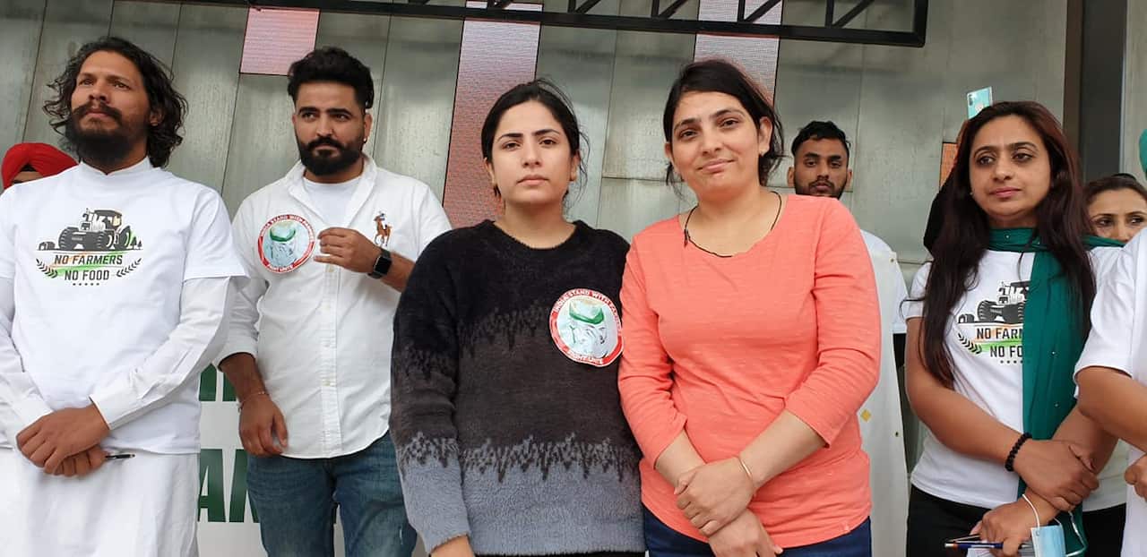 Joti Tikait (orange dress) with event organisers Manvir Kaur (middle) and Raji Mussavar (L)