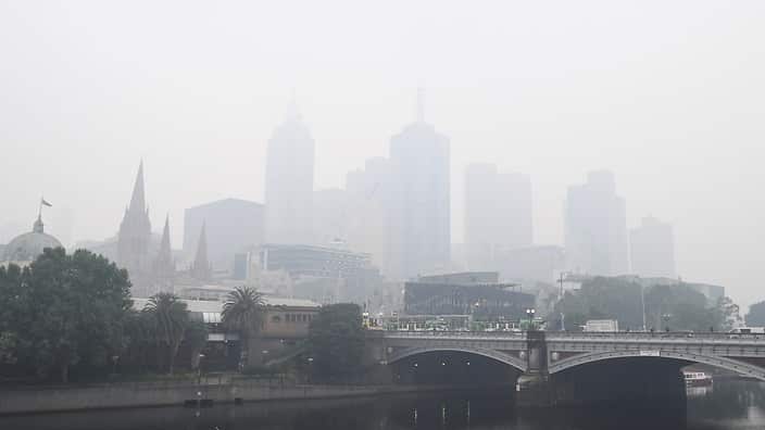 City buildings are seen through smoke haze from bushfires in Melbourne