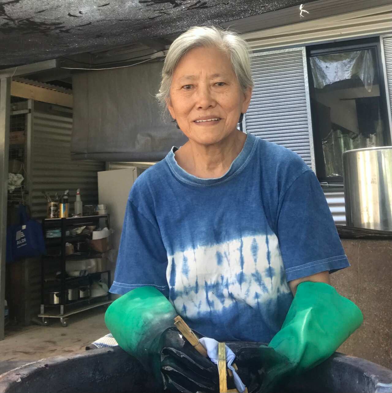 Meng Hoeschle dyeing with indigo at the back of her art workshop. 