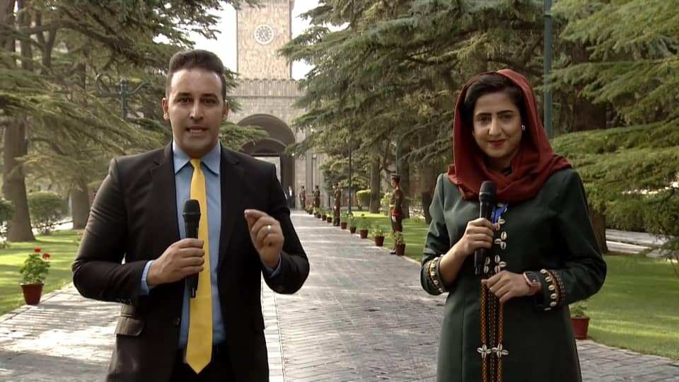 Muska Noori (R) and a colleague reporting from the Afghan presidential palace.