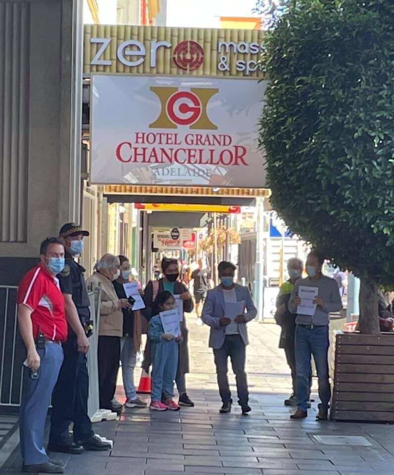Samander with other community members wait outside of hotel quarantine to welcome the new arrivals.