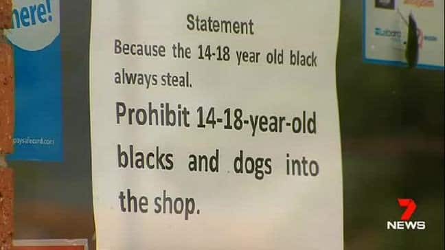 A sign banning black teenagers and dogs from a milk bar in Melton, Melbourne