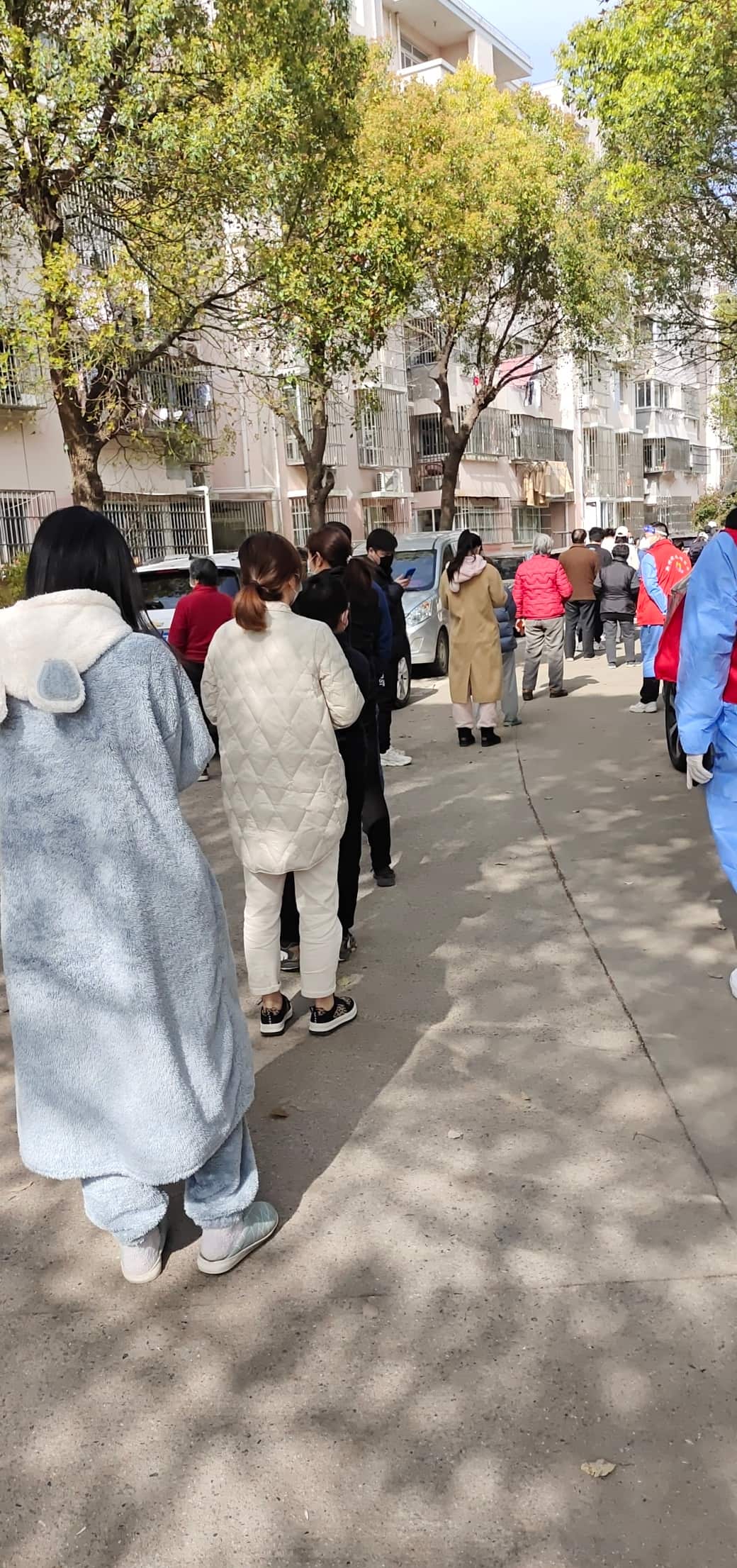 people waiting for PCR test in line during Shanghai Pudong lockdown in March 2022
