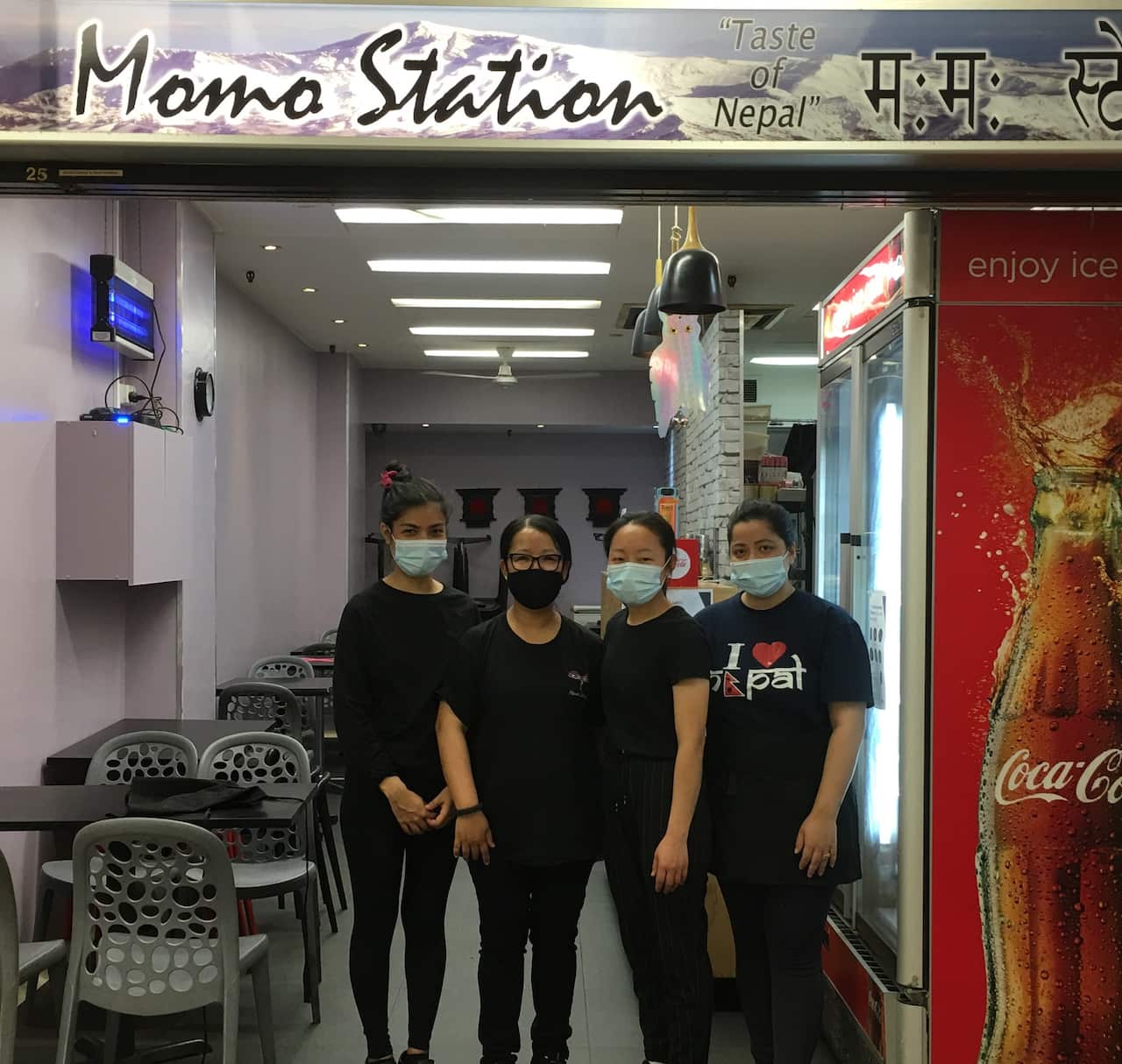 Usha Tangbe (second from right) with her staff at Melbourne's Momo Station restaurant
