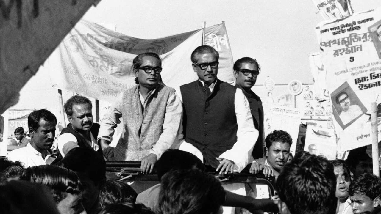 Sheikh Mujibur Rahman, center on Rostrum, leader of East Pakistan's powerful Awami League, addresses an election rally in Dacca, East Pakistan.