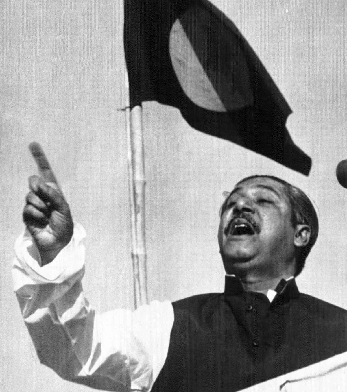 On 7 March 1971, East Pakistan's Awami League party leader Sheikh Mujibur Rehman, addresses a gathering beneath the flag proposed for Bangladesh.