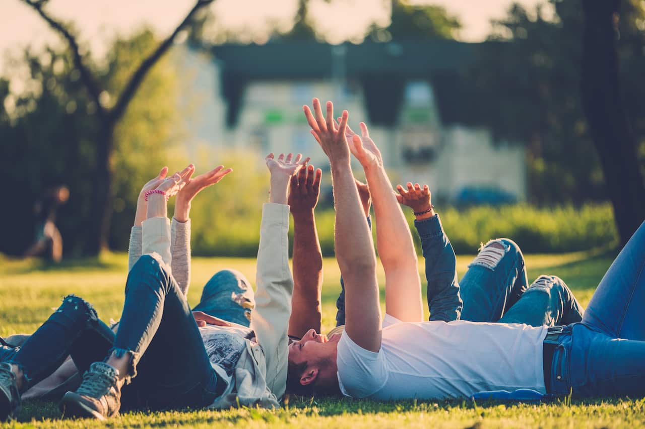 Multi-ethnic group of friends taking a selfie with cellphone.