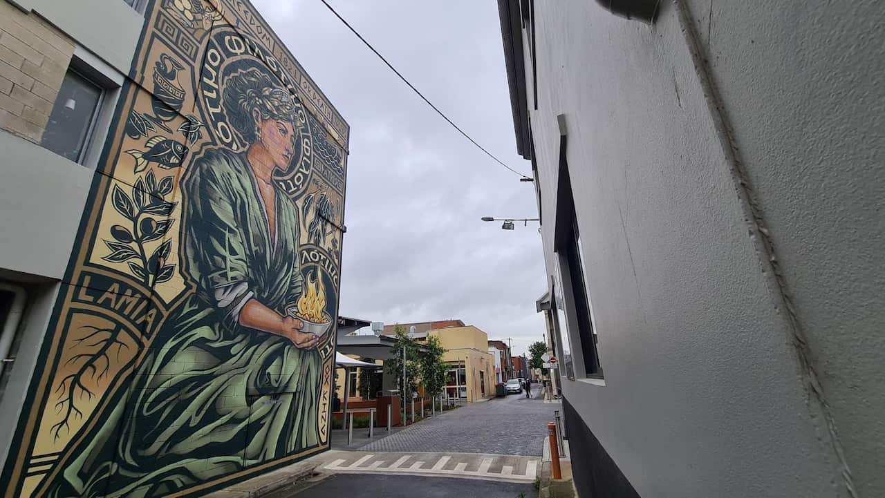 side view of Greek inspired mural in lane