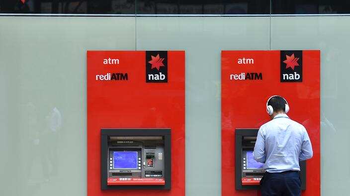 A man uses a National Australia Bank (NAB) ATM in Sydney