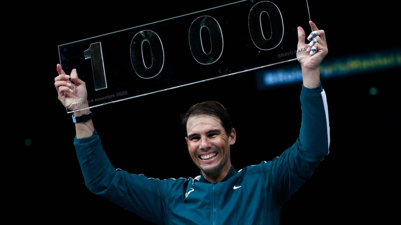 Spain's Rafael Nadal poses with the trophy of his one thousandth victory of the ATP at the end of his match against compatriot Feliciano Lopez during the second round of the Paris Masters tennis tournament at the Bercy Arena in Paris, Wednesday, Nov. 4, 2