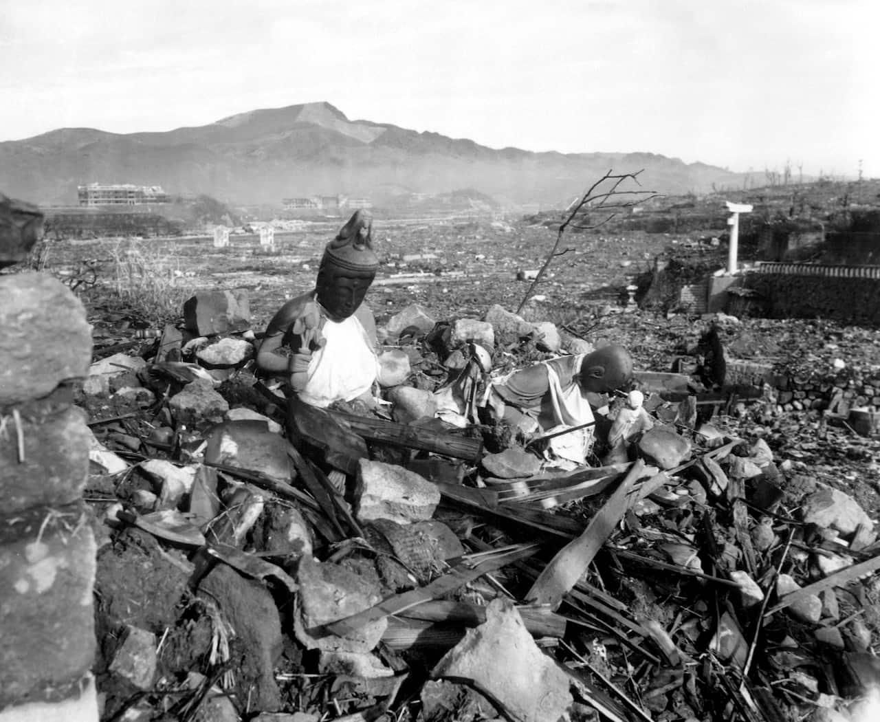 Battered religious figures stand watch on a hill above a tattered valley.  Nagasaki, Japan.  September 24, 1945.  Cpl. Lynn P. Walker, Jr.  (Marine Corps)NARA FILE #:  127-N-136176WAR & CONFLICT BOOK #:  1241