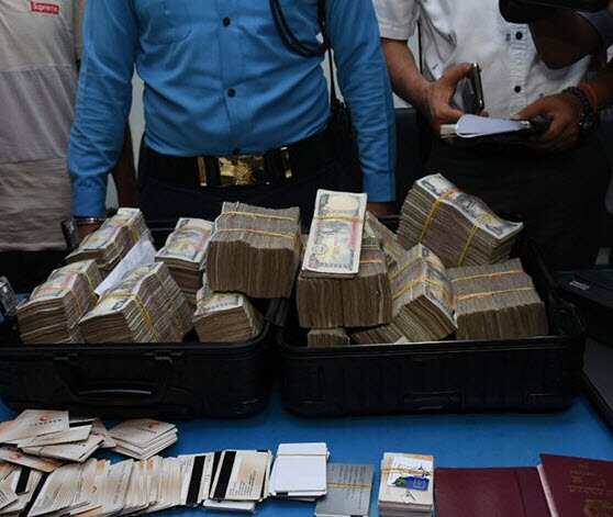 Nepal police display cash and fraudulent credit cards which they say were used by the accused Chinese nationals to allegedly steal money from Kathmandu ATMs