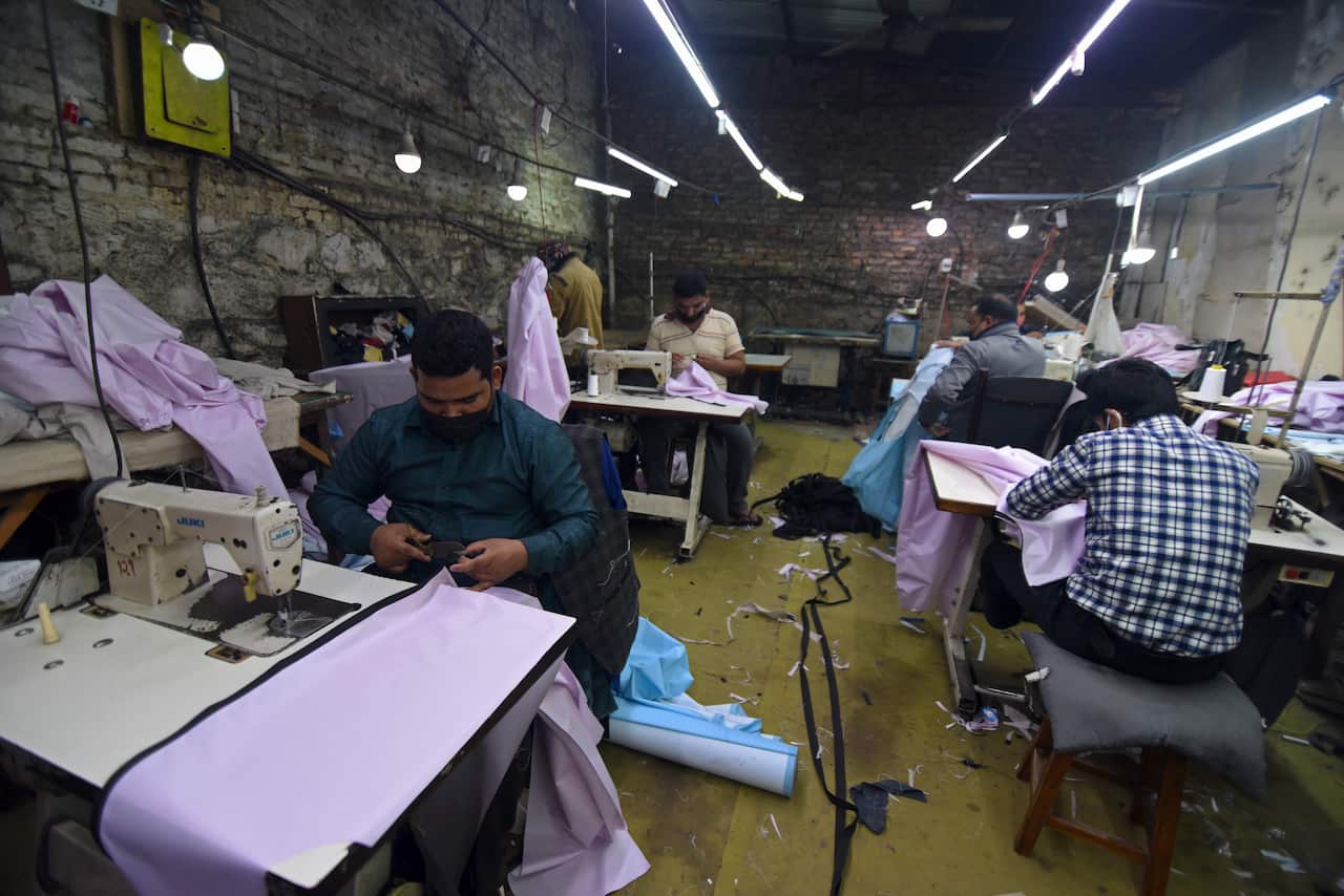 Nepalese workers make Personal Protective Equipment (PPE) dress at a garment factory during the nationwide lockdown due to corona virus  (COVID-19) outbreak, in Kathmandu, Nepal on Friday, March 27, 2020. 
