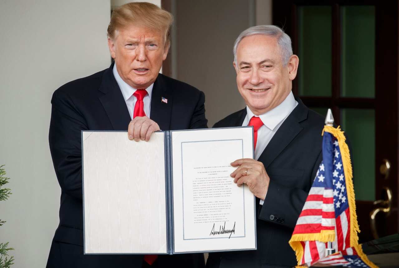 US President Donald J. Trump (L) and Prime Minister of Israel Benjamin Netanyahu (R) display the signed Presidential proclamation on the Golan Heights.