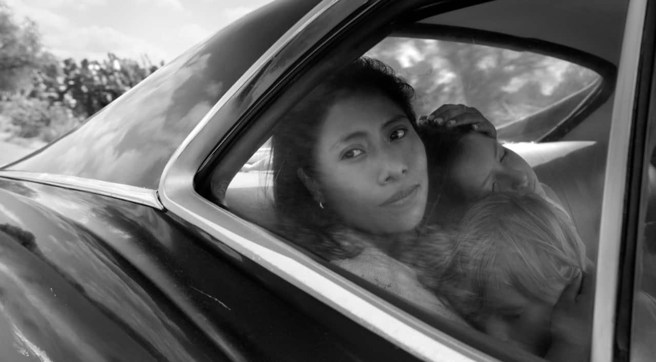 This image released by Netflix shows Yalitza Aparicio, center, in a scene from the film "Roma," by filmmaker Alfonso Cuaron.