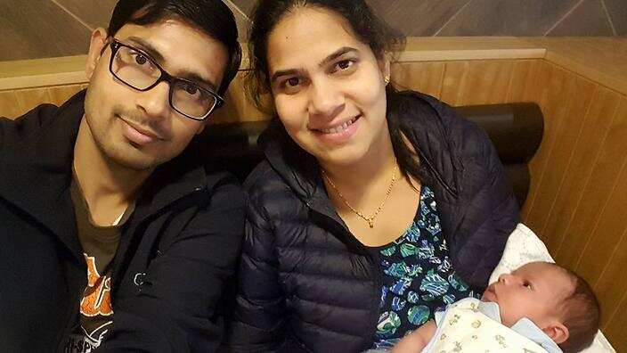 Mohan Kumar (left) with his wife, Nethra Krishnamurthy and infant son, Hari.