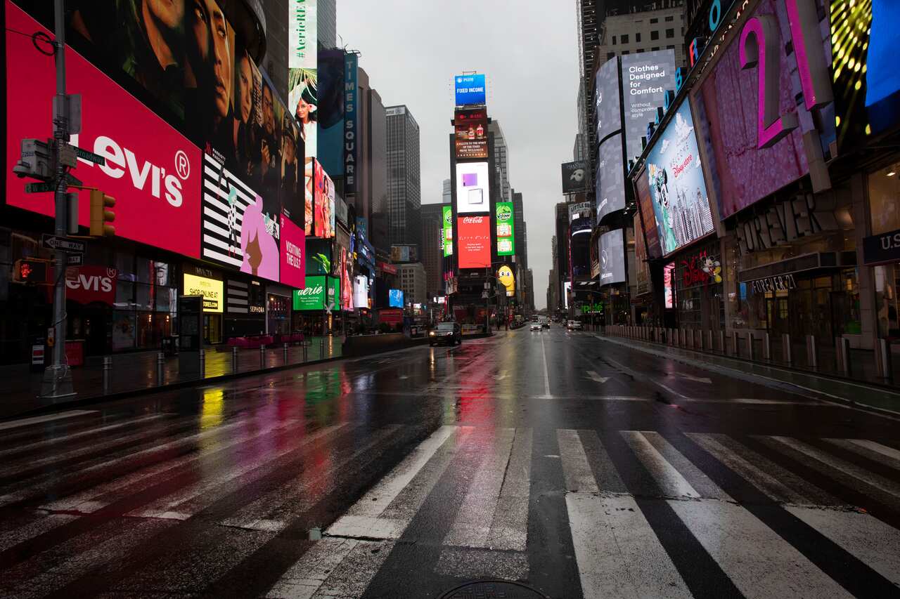 Times Square is mostly empty, Monday, March 23, 2020 in New York. Gov. Andrew Cuomo has ordered most New Yorkers to stay home from work to slow the coronavirus pandemic. (AP Photo/Mark Lennihan)