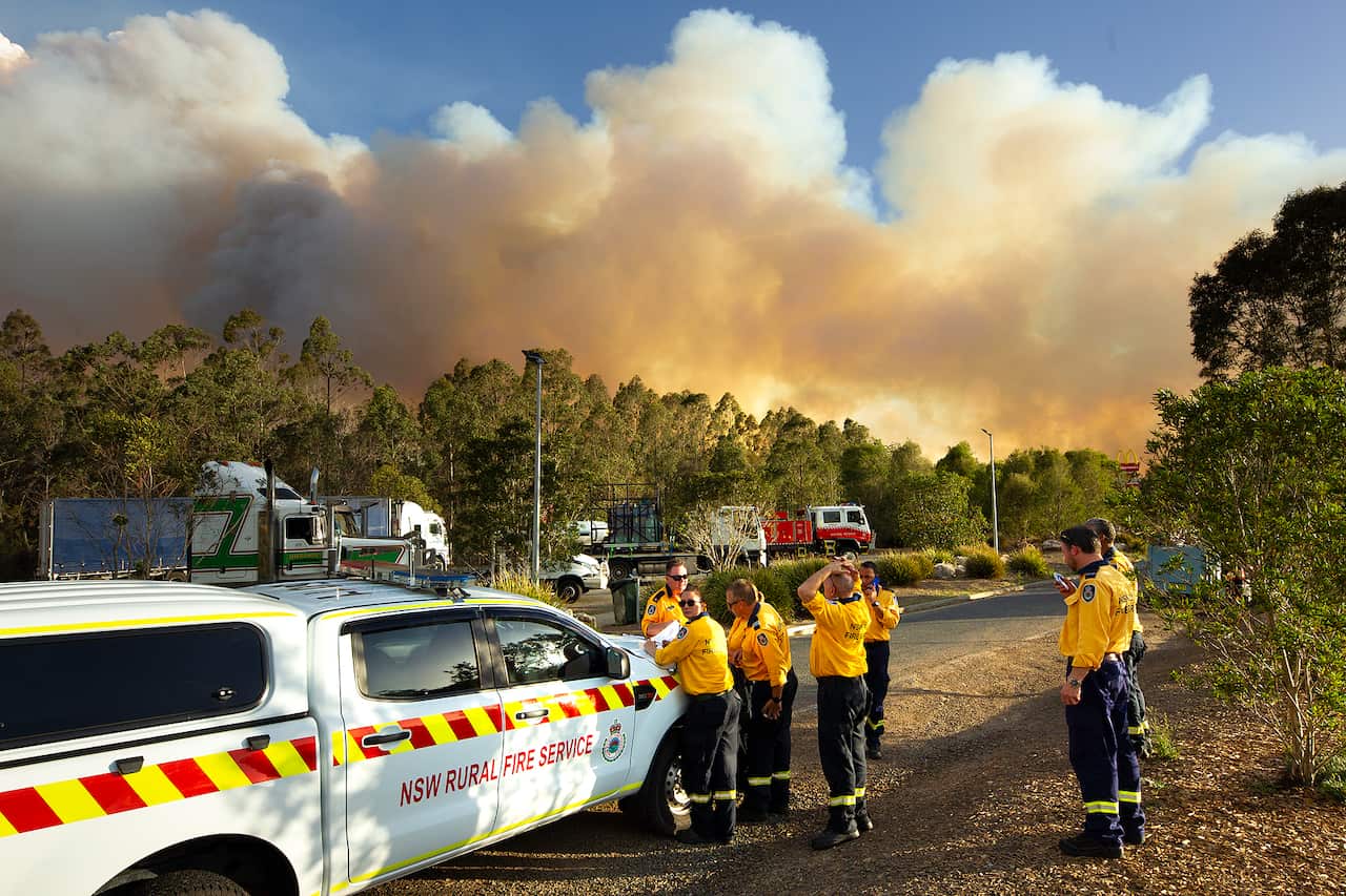 Smoke is seen near a closed highway by Taree, Friday, November 8 2019.