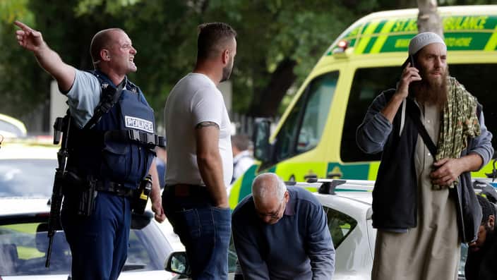 Police attempt to clear people from outside a mosque in central Christchurch, New Zealand,