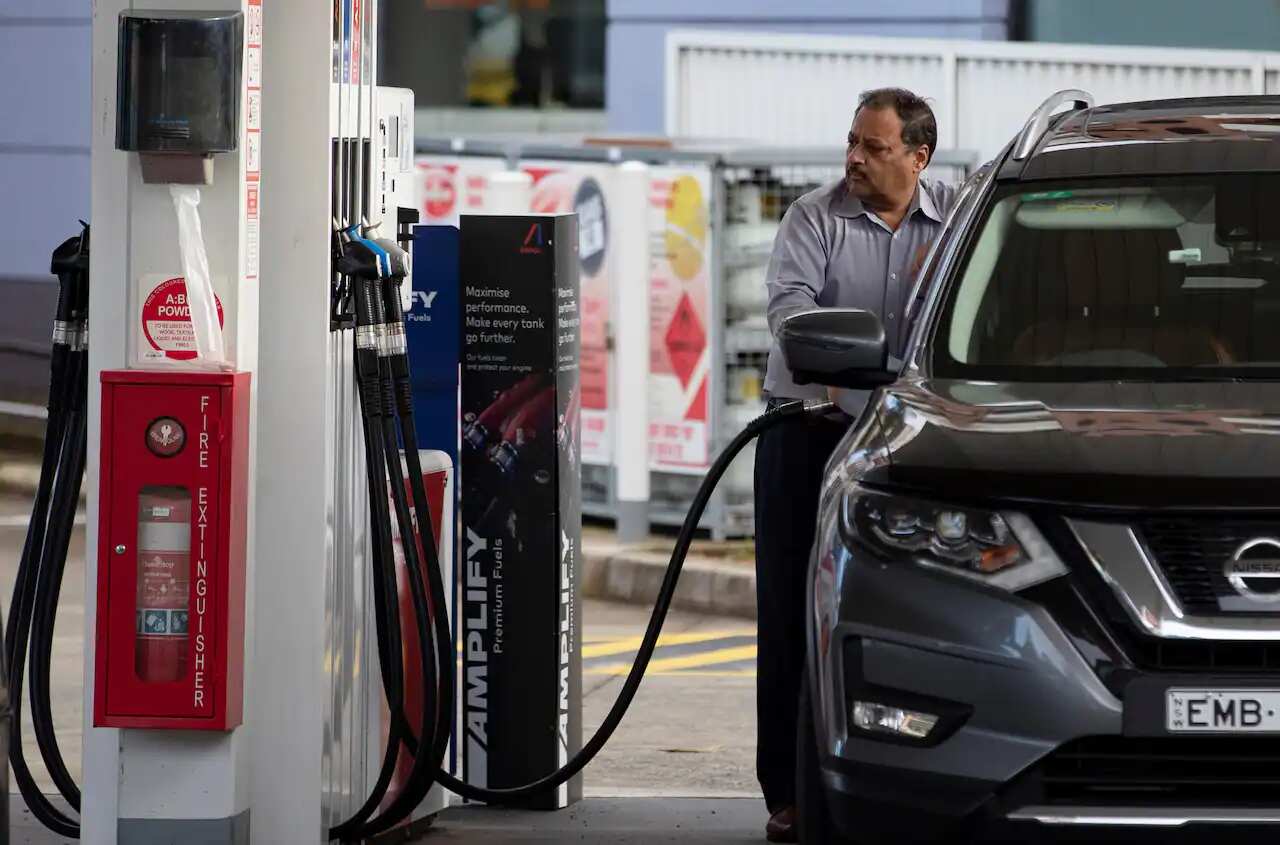 A man fills up his car at a petrol station in Sydney, Australia as fuel hits record prices in many areas across the country. 