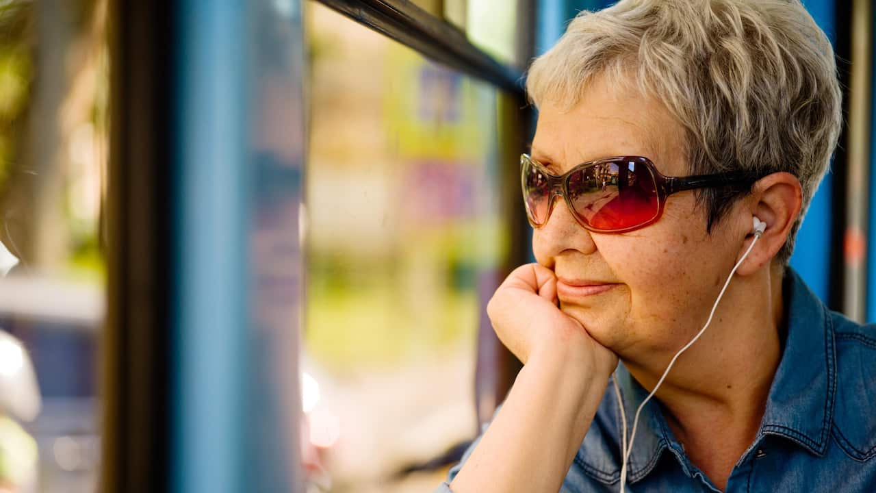 Old lady looking out window
