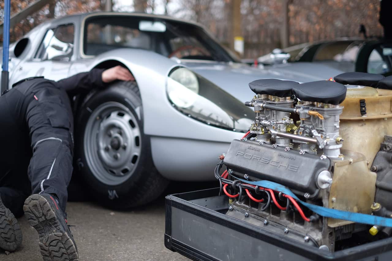 A mechanic working with a car