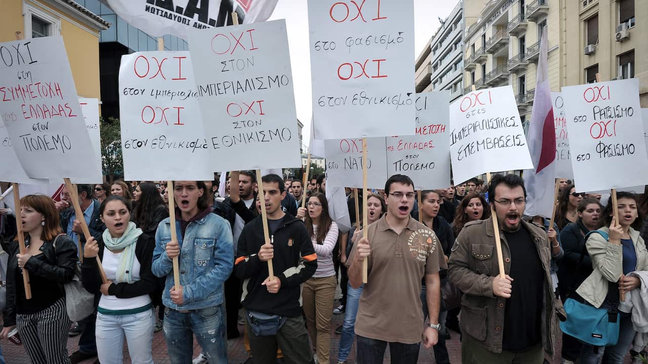 Youth with placcards with Greek no insciptions