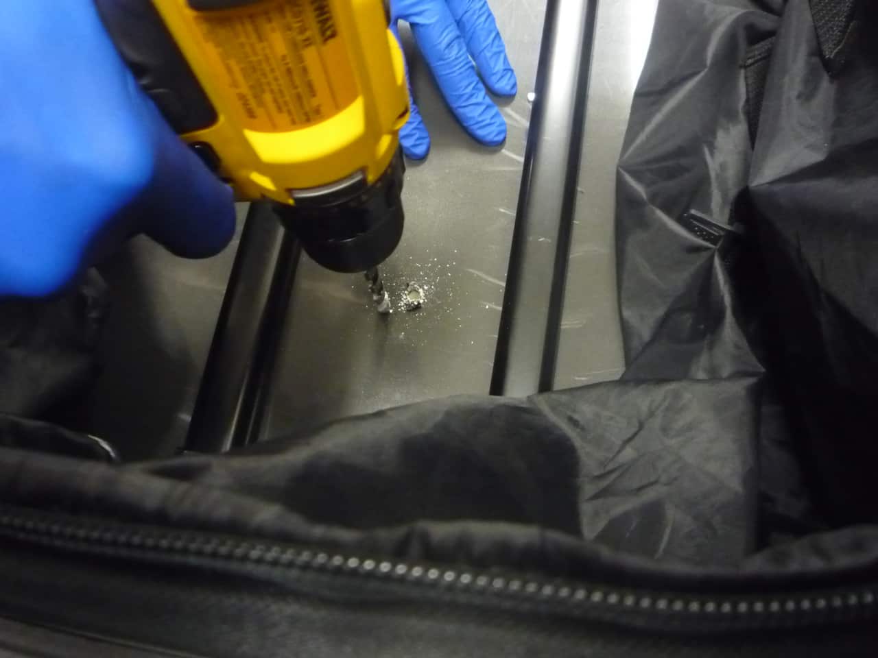 suitcase being drilled