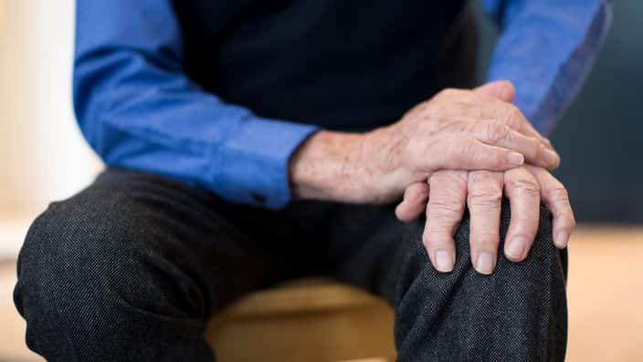 Close Up Of Senior Man Suffering With Parkinsons Diesease