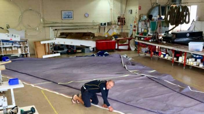 Vladimir Kulinichenko working on the sail