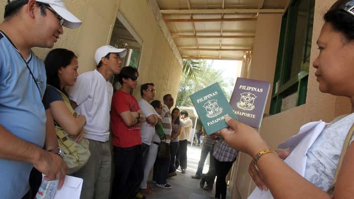 Filipinos living overseas wait in line t