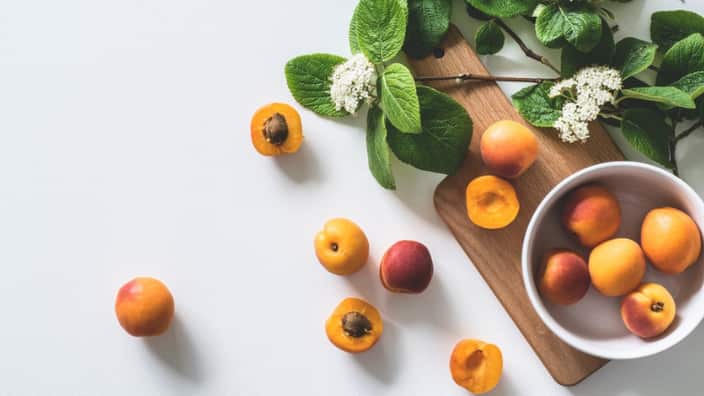 bunch of brown fruits near flowers