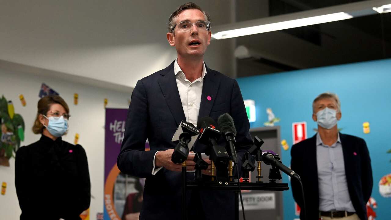 NSW Premier Dominic Perrottet (centre) speaks to the media during a press conference at South Western Sydney Vaccination Centre in Sydney, Wednesday, January 5.