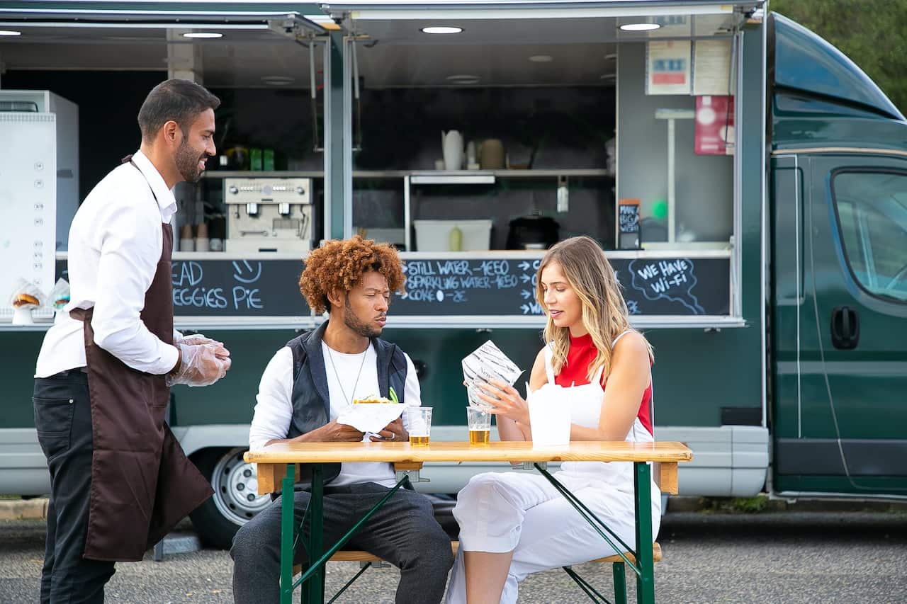 A representative image of a food van worker serving his customers.