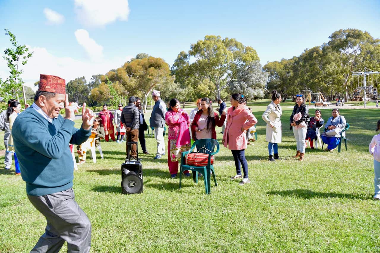 Visiting Nepali Parents in a park in Adelaide enjoying a community Barbecue event 
